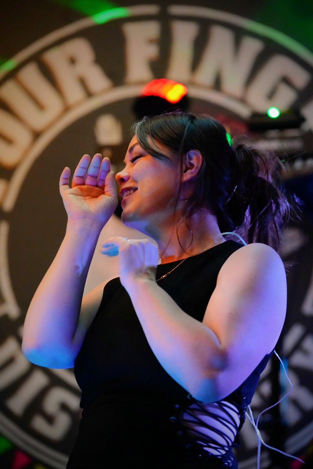Vocalist on stage, eyes closed
